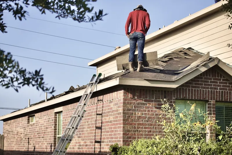 Professional roofer working on a residential roof in Madera Acres